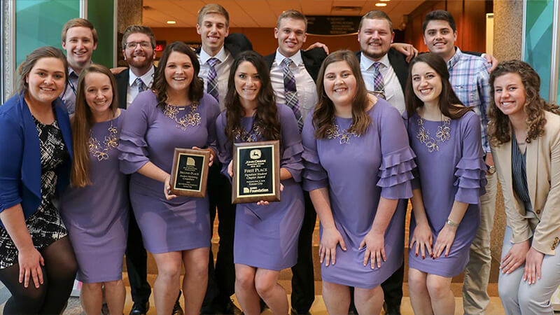 Students holding trophy from competition