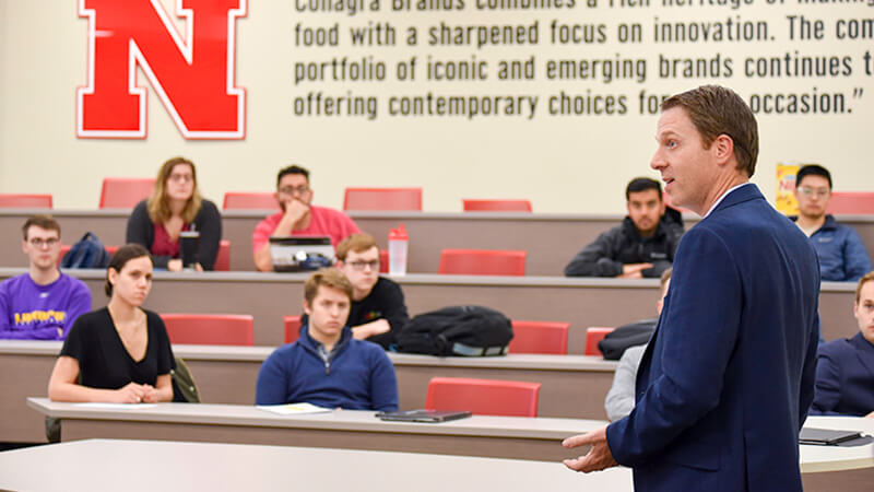 Students listen to a professor in a finance lecture.