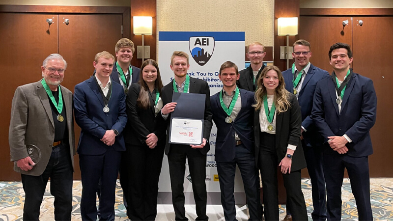 Students holding awards after student competition