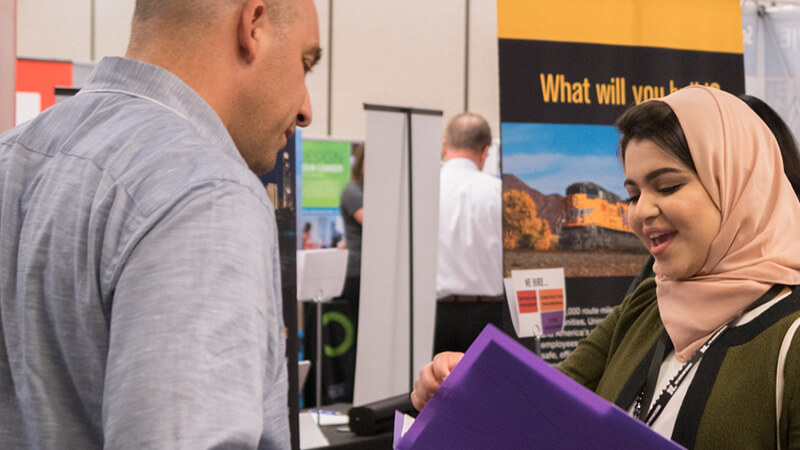 Student talking to employer at career fair