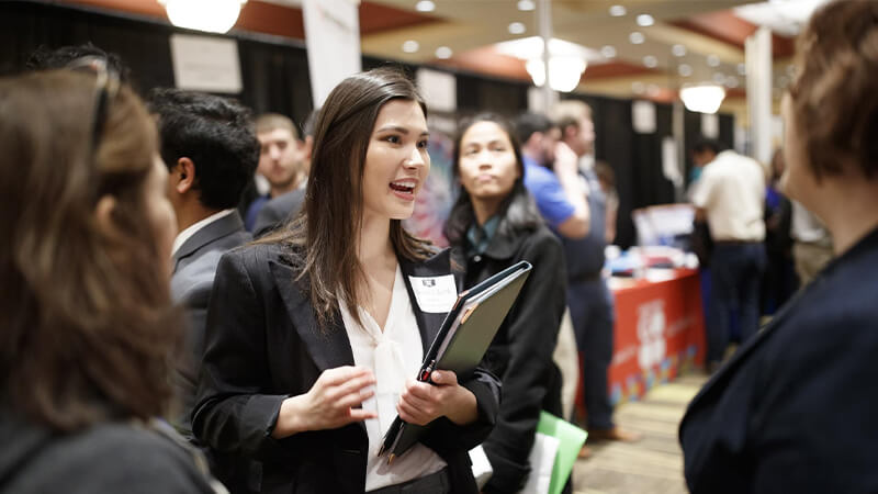 Student talking with employer at career fair