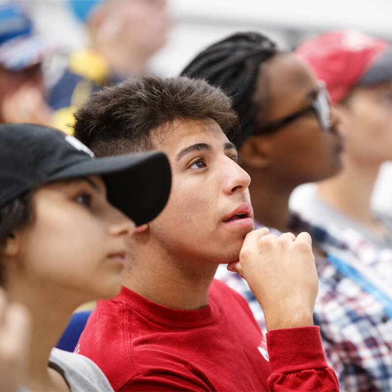 Students learn in a lecture hall setting.