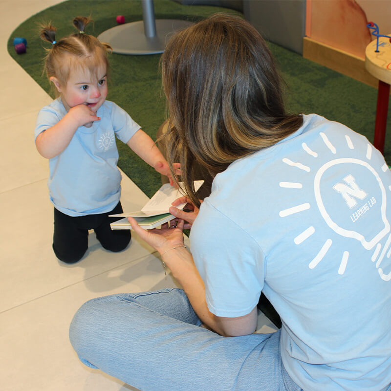 Student working with toddler