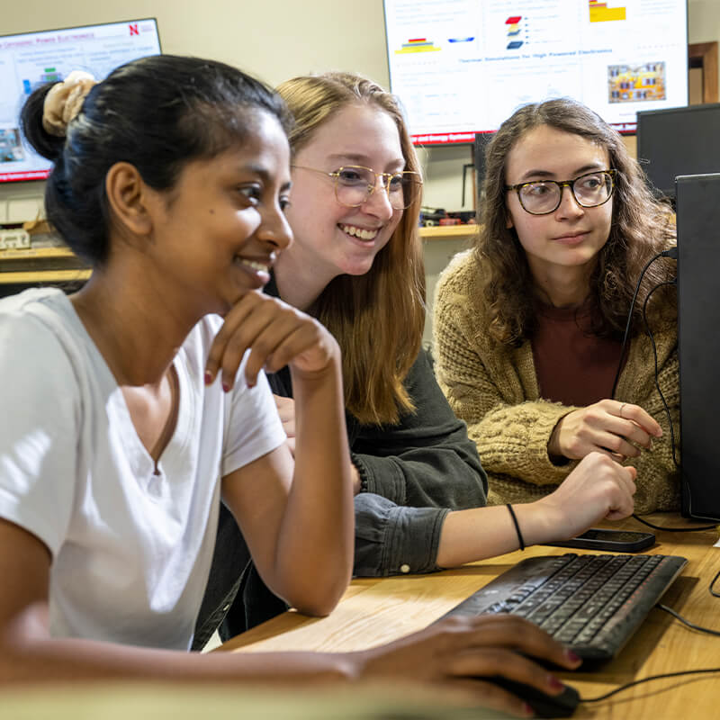 Students looking at computer monitor