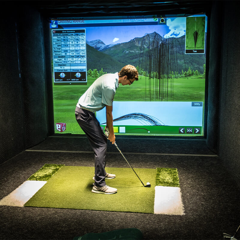 Student using golf simulator