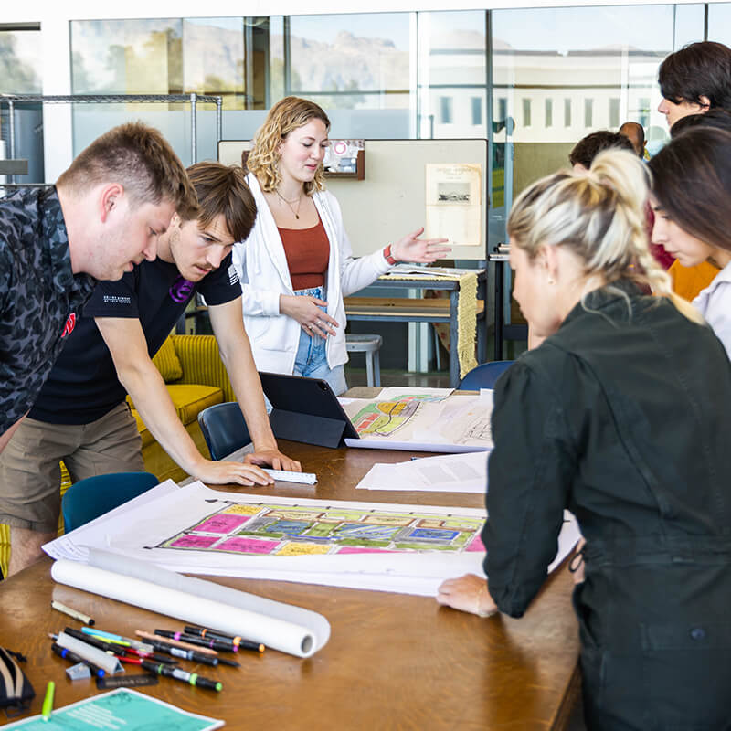 Students looking at work on table