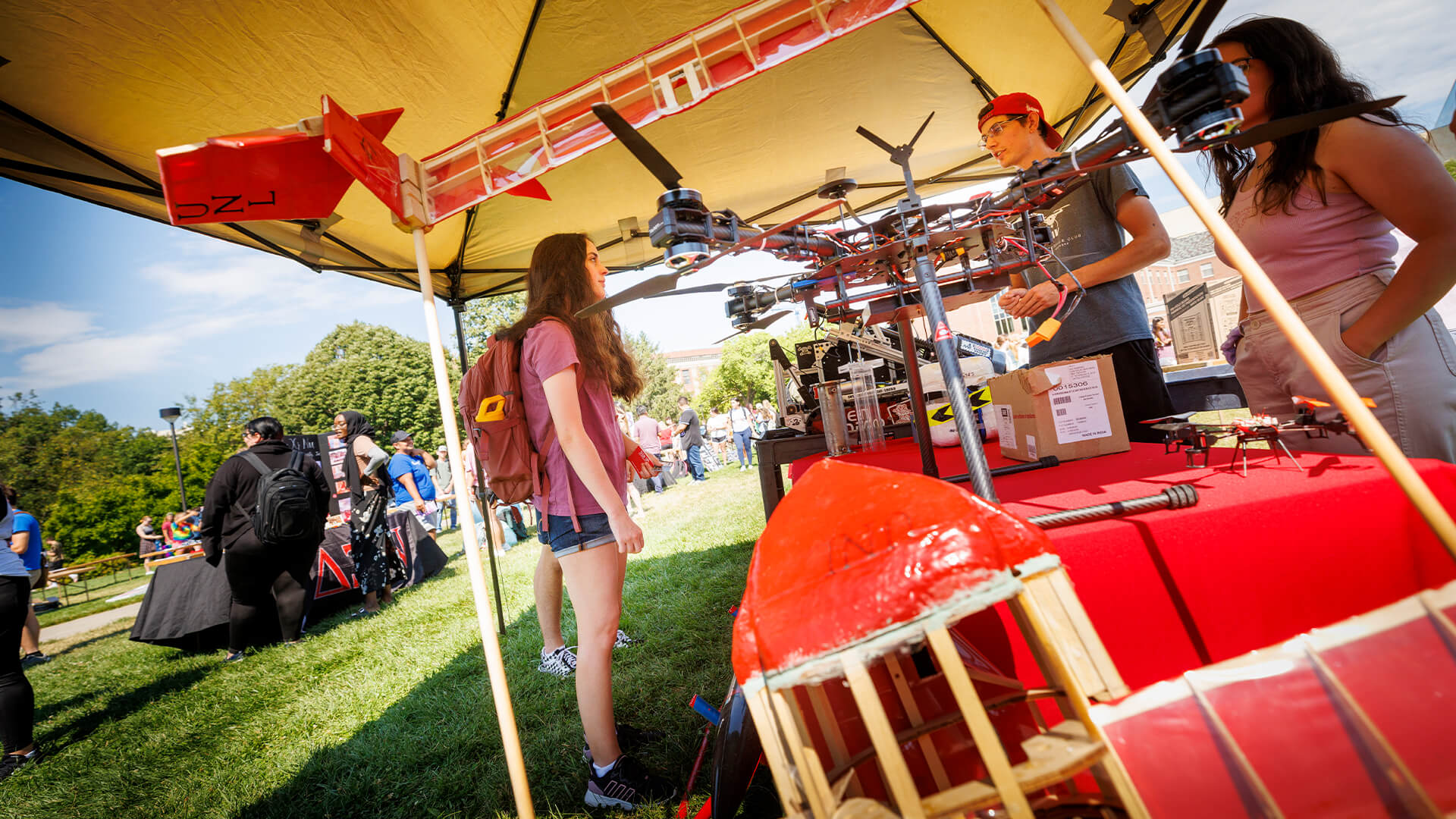 Student talking to others at drone demonstration