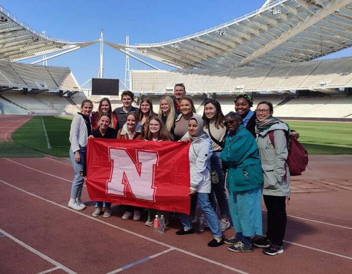 Students holding Nebraska flag on Education Abroad trip