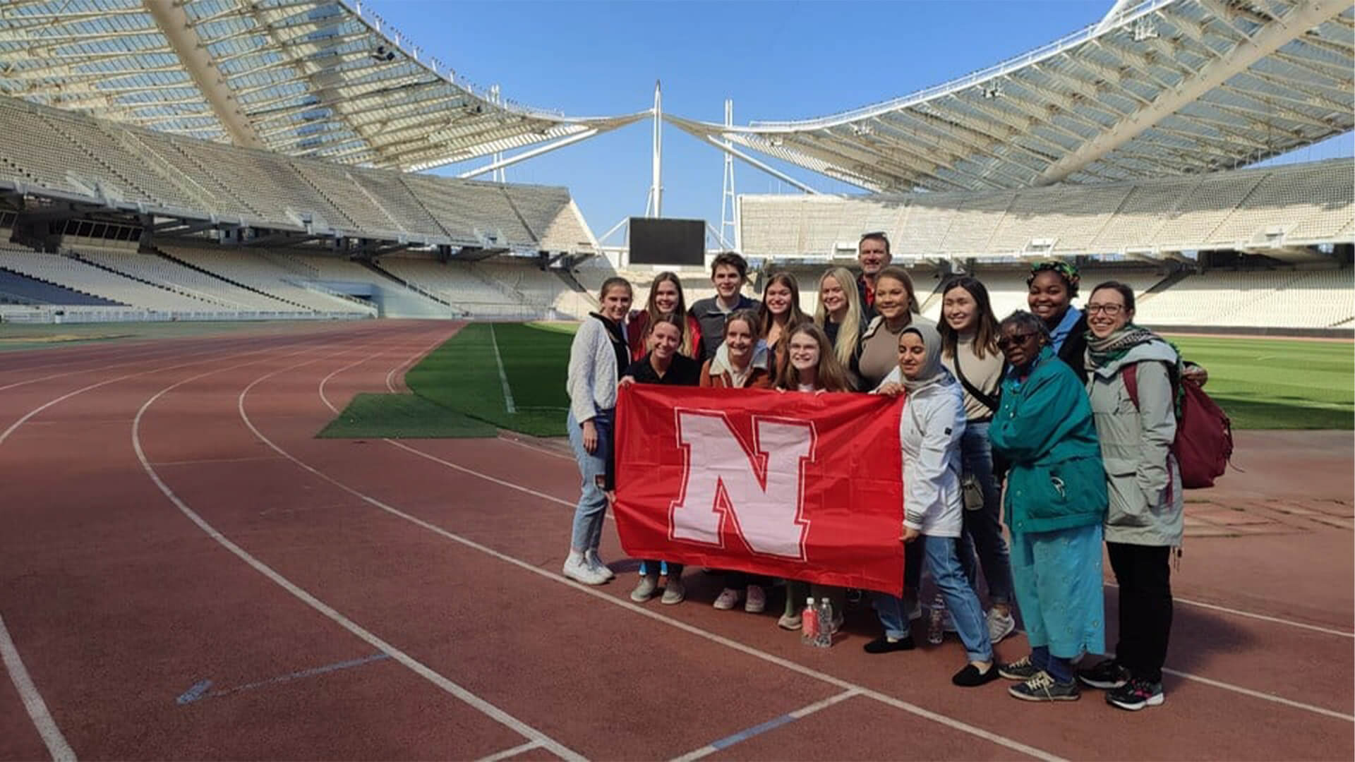 Students holding Nebraska flag on Education Abroad trip
