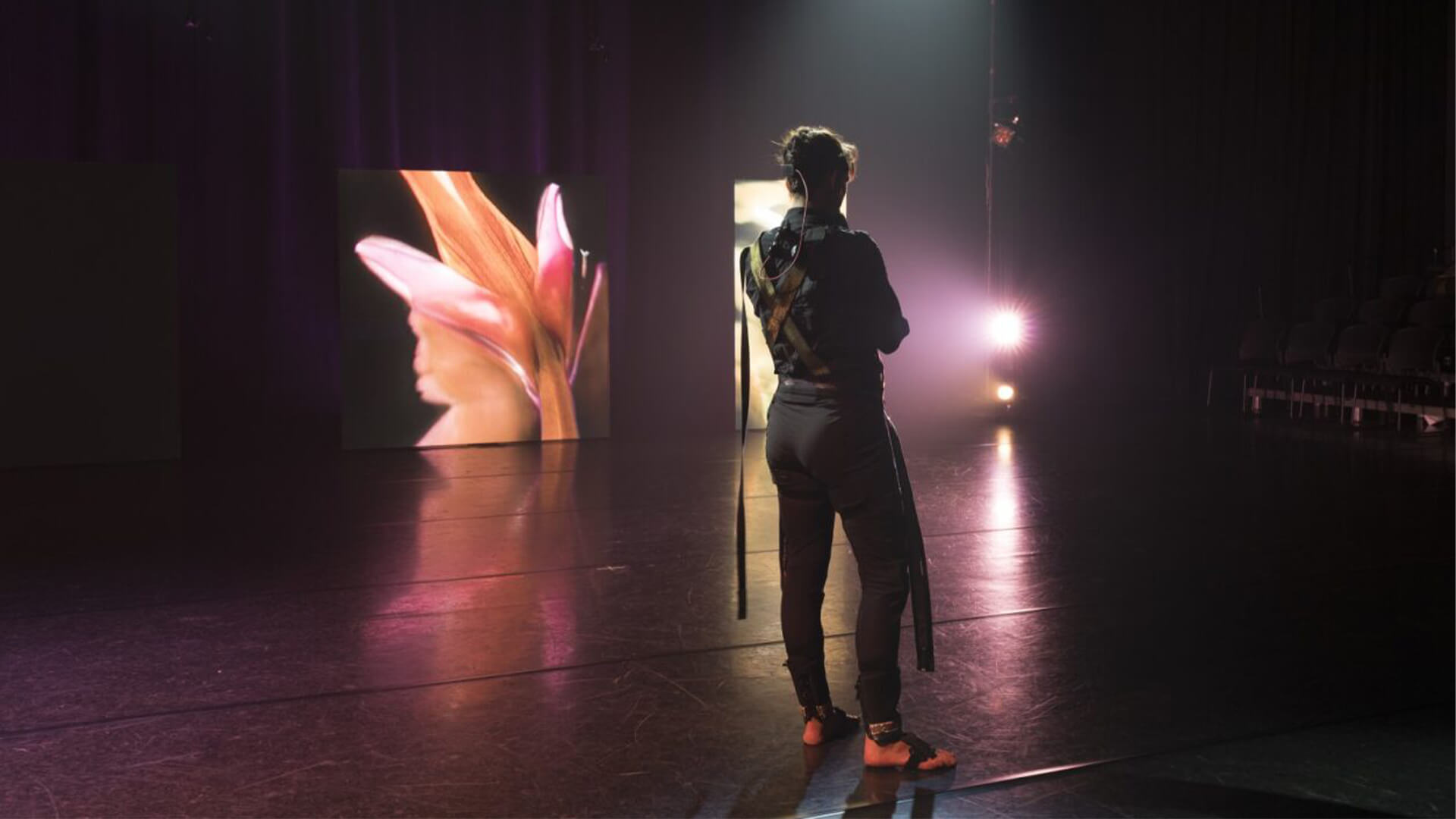 Backlit student on stage