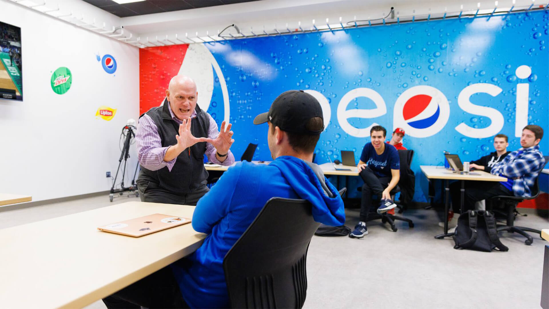 Professsor talking to students in classroom