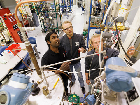 Students looking at overflow pipes in lab