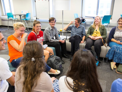 Students having a discussion in a classroom.
